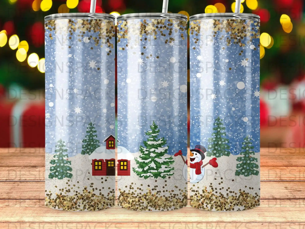 Snowman, red house, and pine trees on a sparkling blue Christmas tumbler.