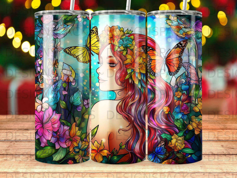 Tumbler with colorful floral and butterfly art featuring a woman's profile.