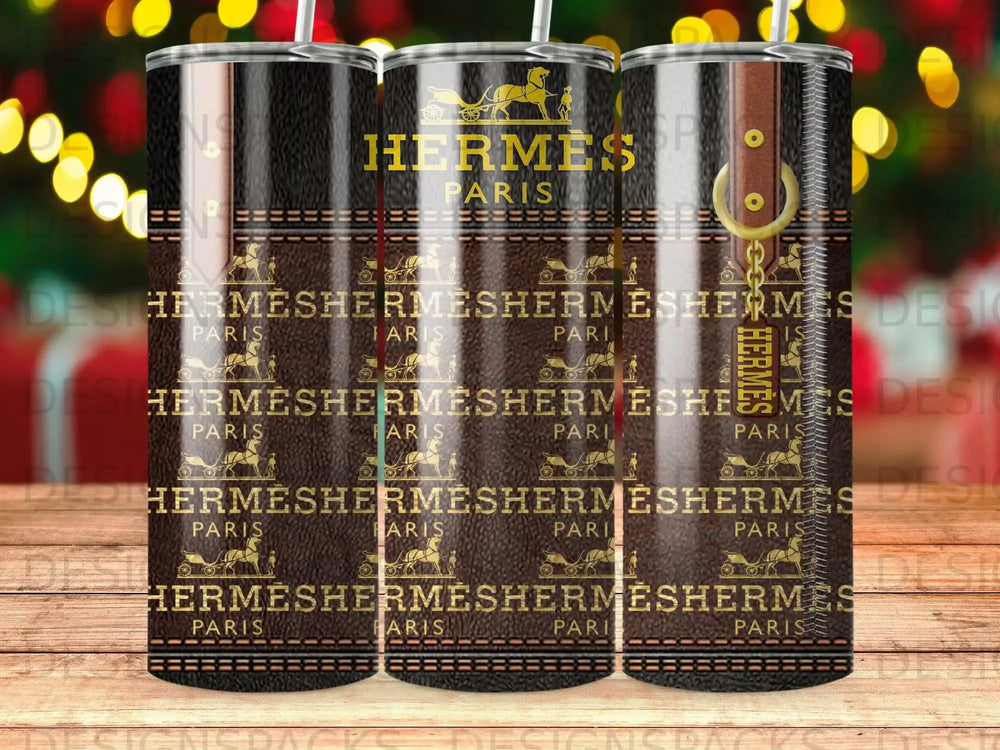 Three Hermès Paris tumblers with repeating logo and leather strap accents.