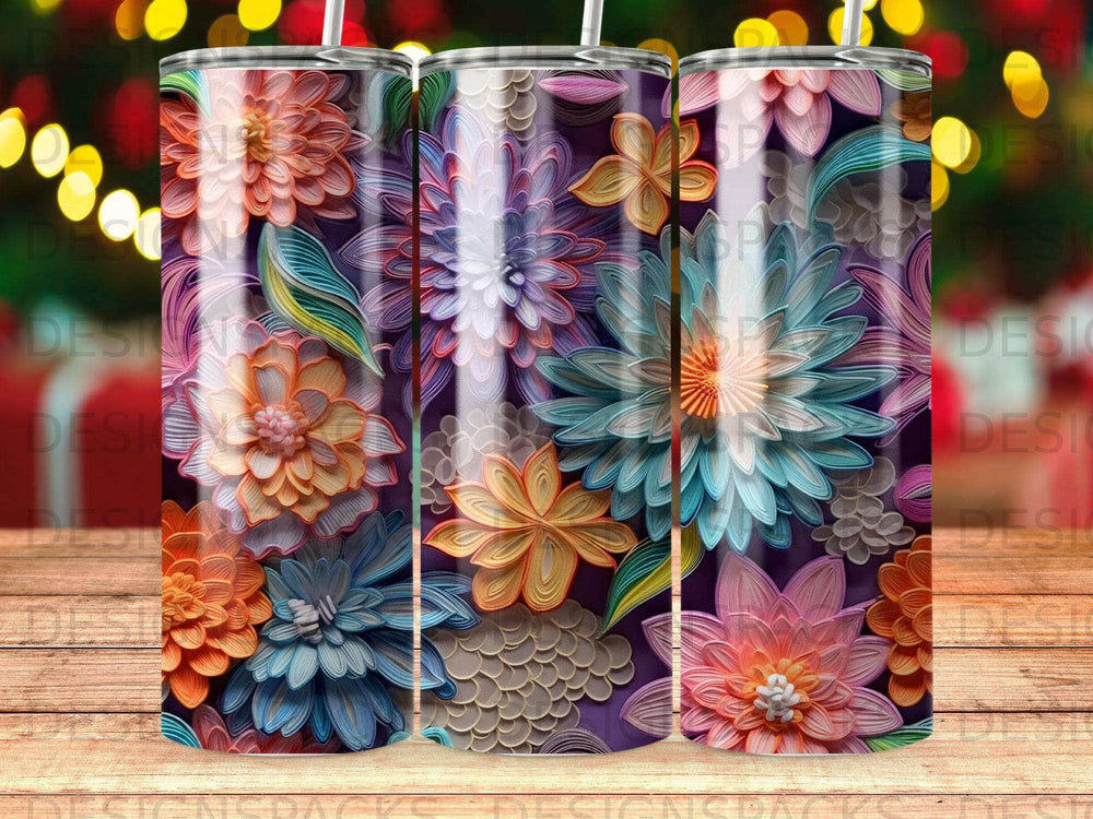 Three tumblers with colorful floral patterns against a dark background.