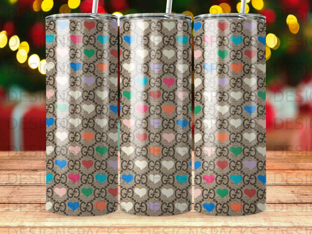 Pattern of Gucci logo and hearts on a tumbler.