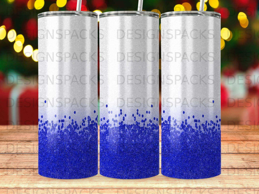 Blue glitter gradient on a white tumbler with "DESIGNSPACKS" watermark.