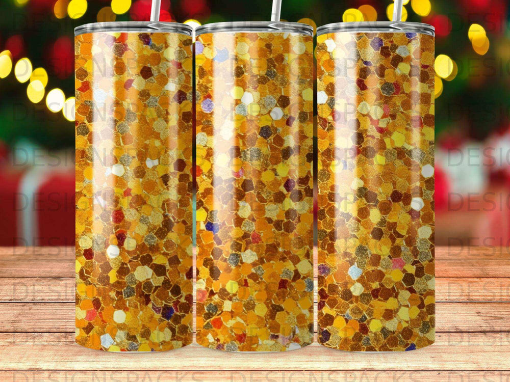 Three gold glitter tumblers with straw stands against a bokeh background.