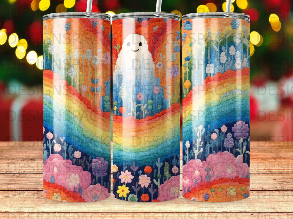 Ghost with rainbow, flowers, and clouds on a patterned tumbler.