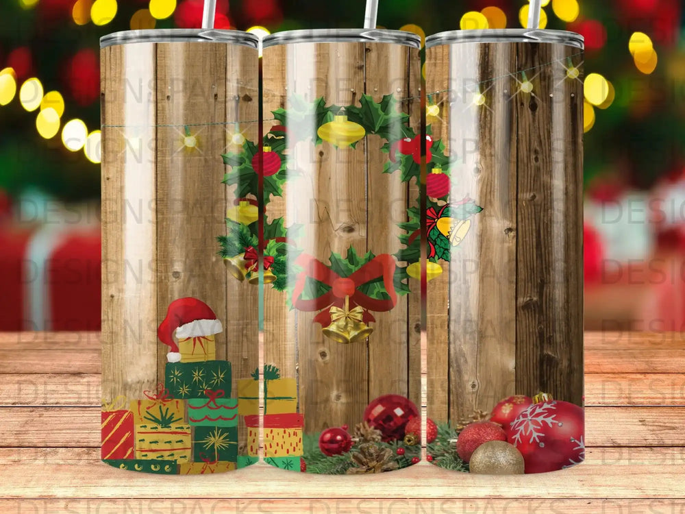 Holiday tumbler with Christmas wreath, gifts, and ornaments on rustic wood.