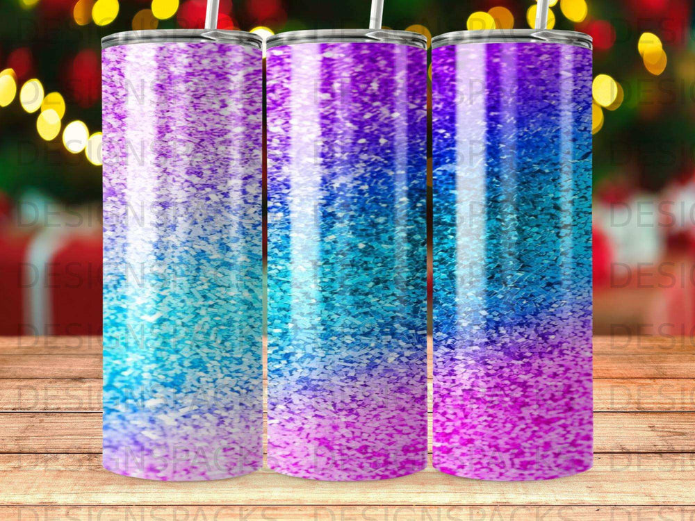 Three tumblers with a glitter ombre design in blue, purple, and pink.