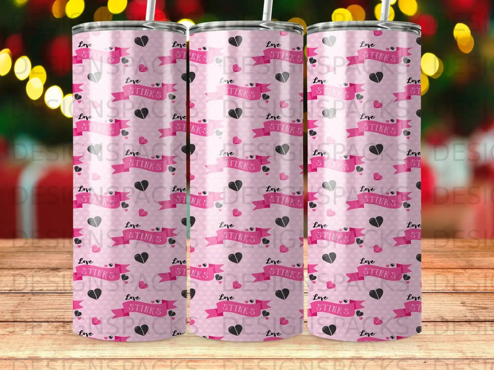 Pink tumbler with repeating "Love Stinks" text and heart patterns.