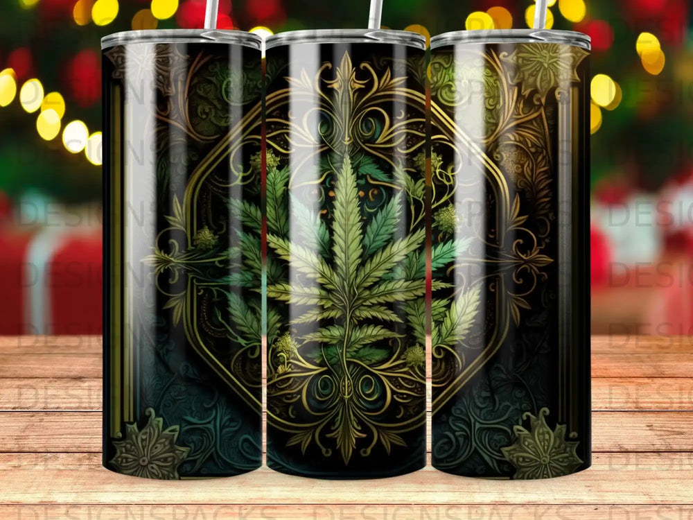 Black tumbler with ornate gold cannabis leaf design and bokeh background.