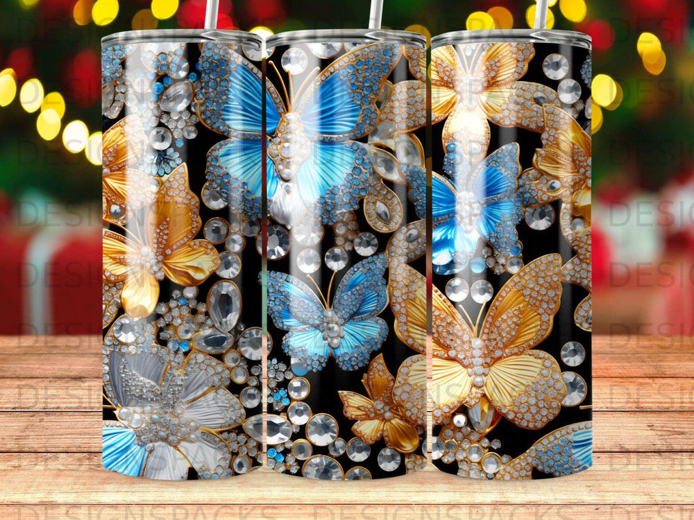 Tumblers with blue and gold butterfly designs and scattered rhinestones.