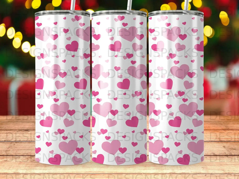 Three tall, skinny tumblers with a repeating pink heart pattern.