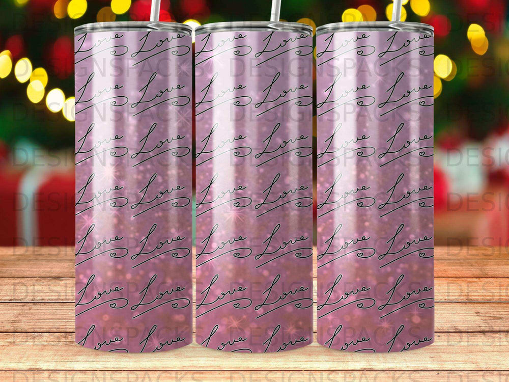 Pink glitter tumbler with repeating "love" pattern and blurred festive background.
