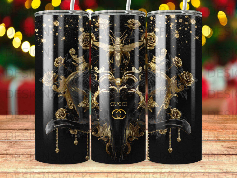 Gold bee, skull, and roses on a black tumbler with glitter.