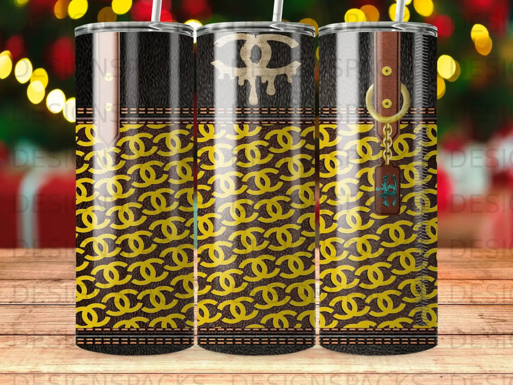 Trio of tumblers with black and gold interlocking 'C' pattern, leather texture, and tassel charm.