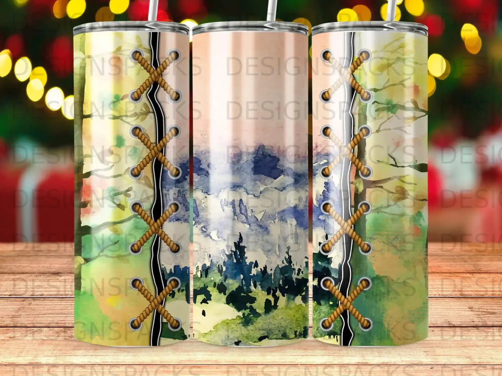 Three tumblers with a watercolor forest and sky design, laced with rope.