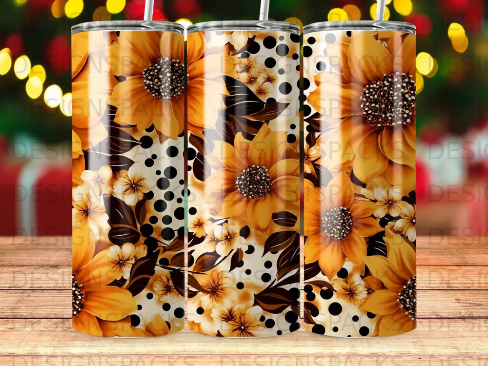 Three tumblers with a floral and polka dot sunflower design on a wooden surface.