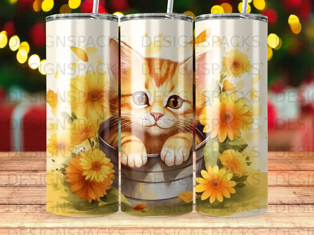 Kitten peering from a bucket surrounded by sunflowers on a tumbler.