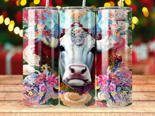 White cow face with colorful floral crown, centered on three tumblers.