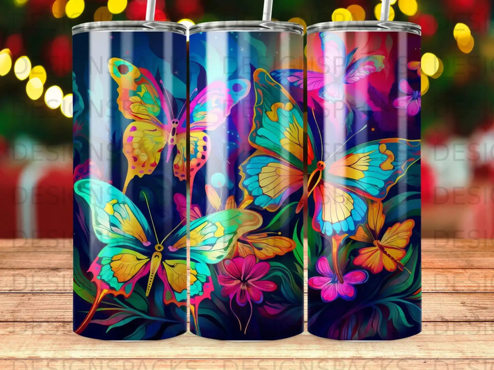 Three tumblers with vibrant butterfly and floral designs.