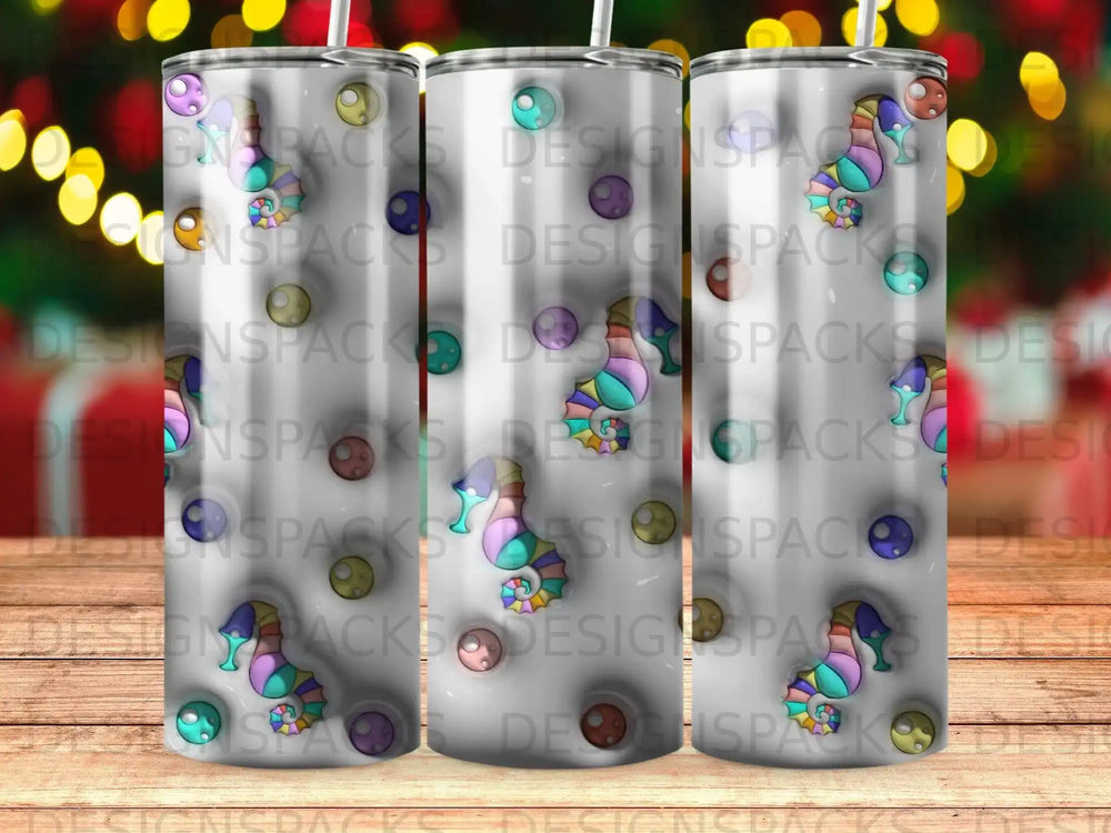 Three tumblers with colorful patterned designs and a repeating logo.