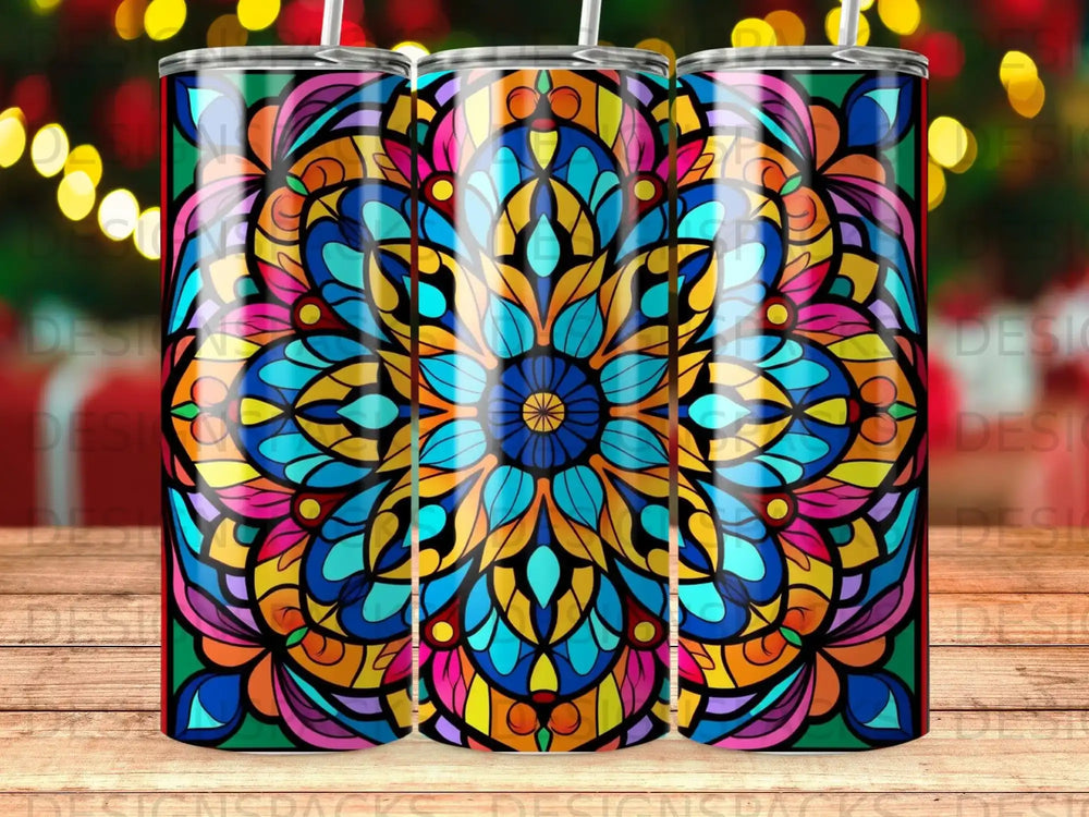 Colorful stained glass mandala pattern on a tumbler with bokeh lights in background.