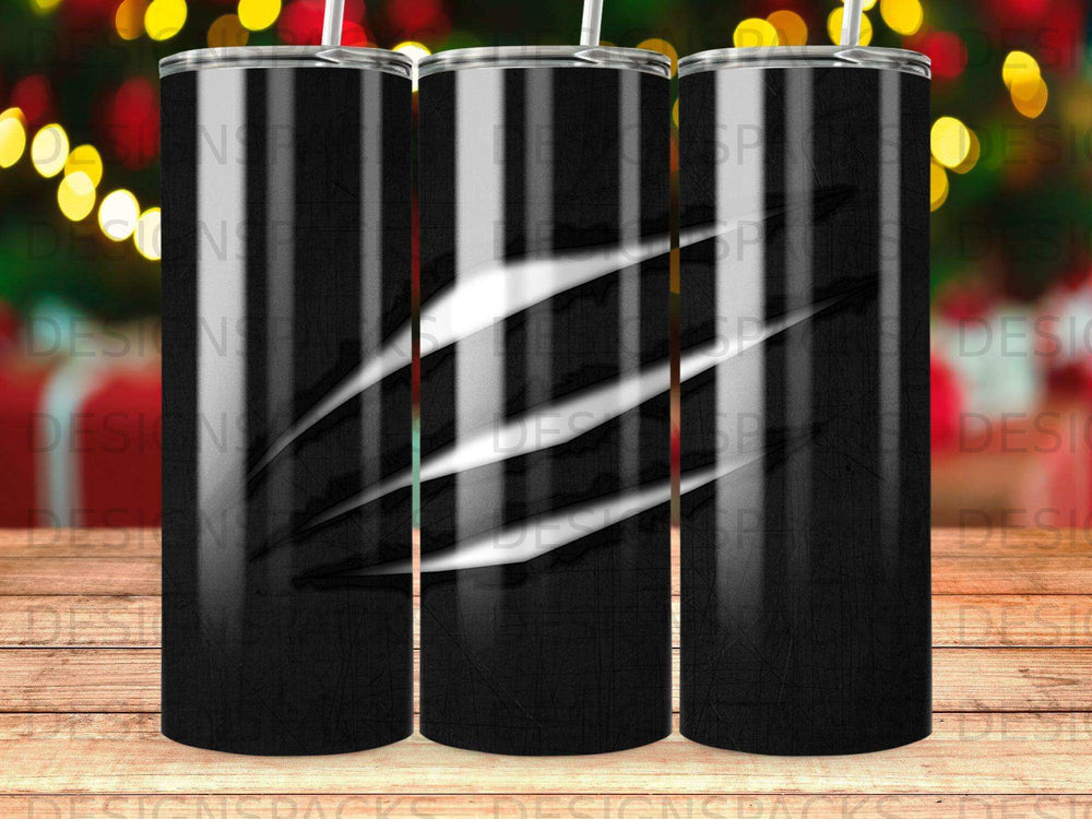 Black tumbler with white claw marks and festive bokeh lights in background.