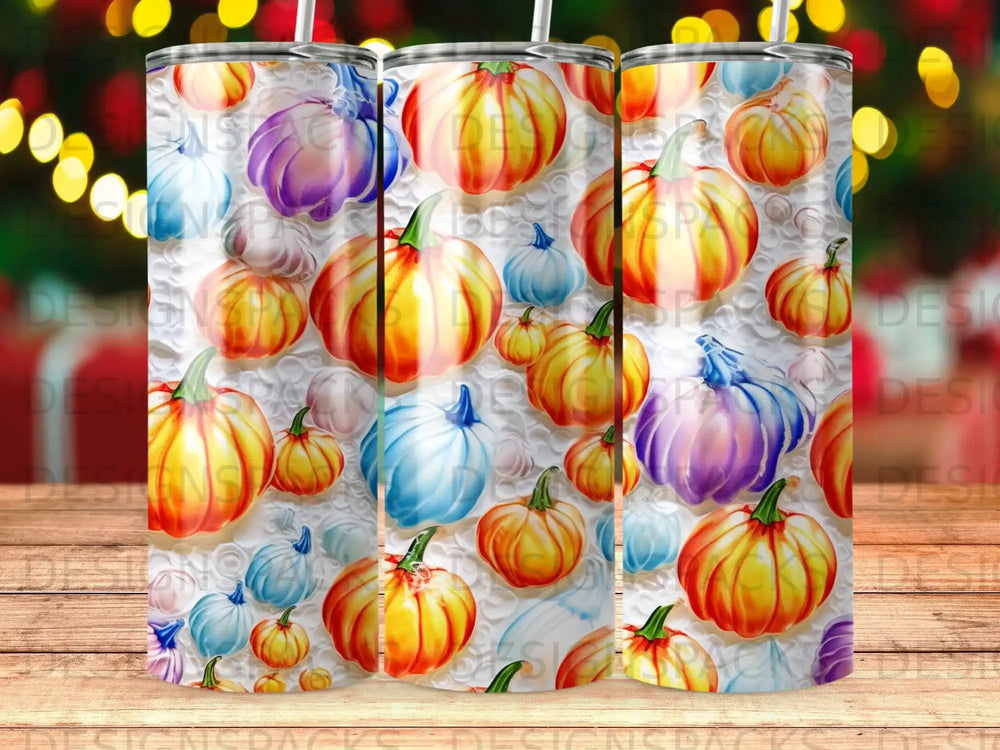 Three tumblers featuring a colorful pumpkin pattern on a white background.