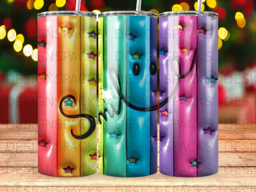 Three tumblers with colorful smiley face and star designs.