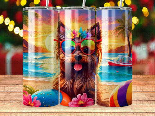 Yorkshire terrier wearing sunglasses and flowers at the beach.