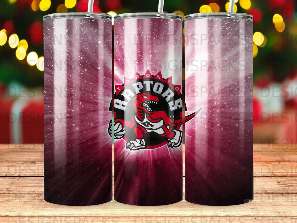 Toronto Raptors logo on a dark red, sunburst-patterned tumbler.