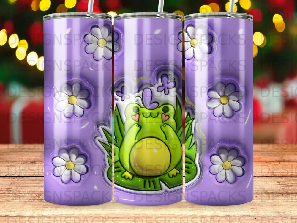 Purple tumbler with a smiling frog on a lily pad, surrounded by flowers.