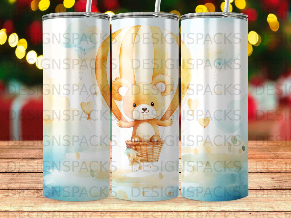 Teddy bear in hot air balloon, watercolor style with "DESIGNSPACKS" watermark.