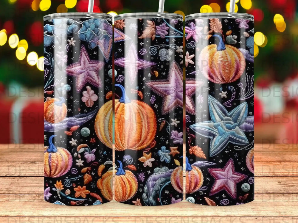 Pumpkin and star pattern on a dark background, repeating on three tumblers.