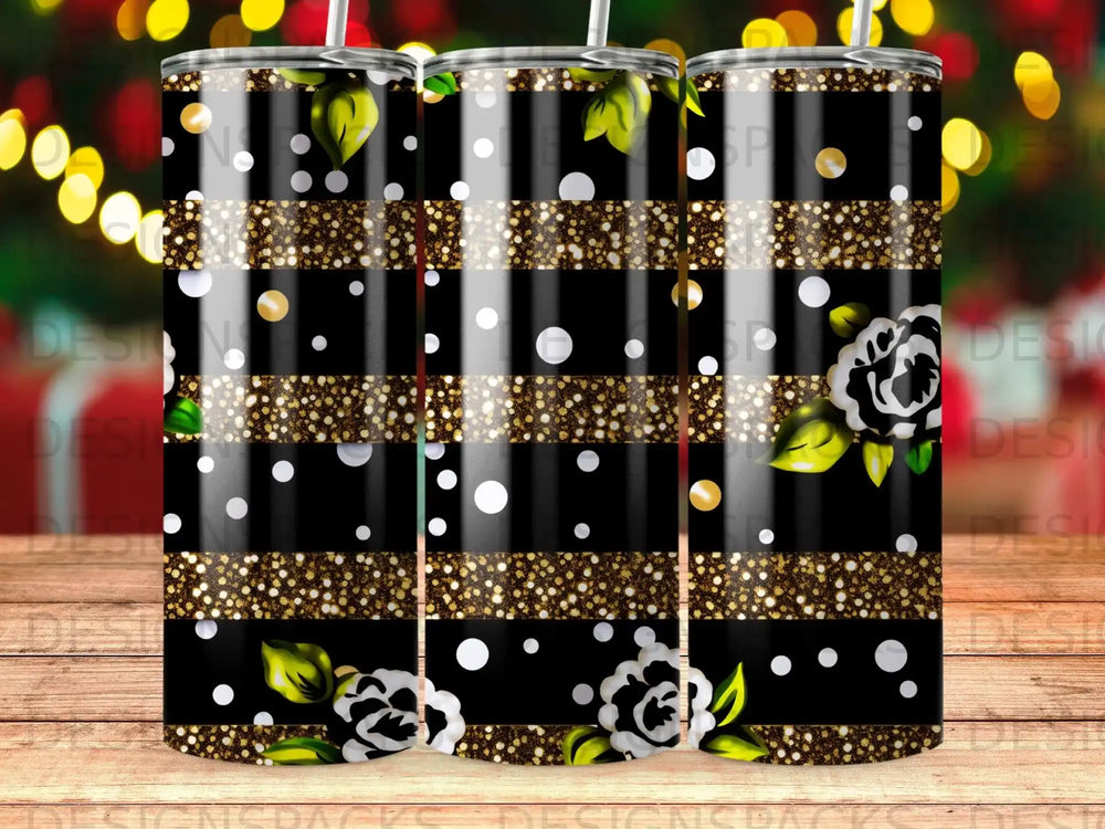 Black tumbler with gold glitter stripes and white floral pattern.