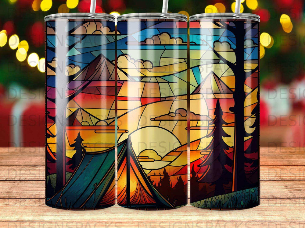 Stained glass design with mountains, trees, tent, and sunset on a tumbler.