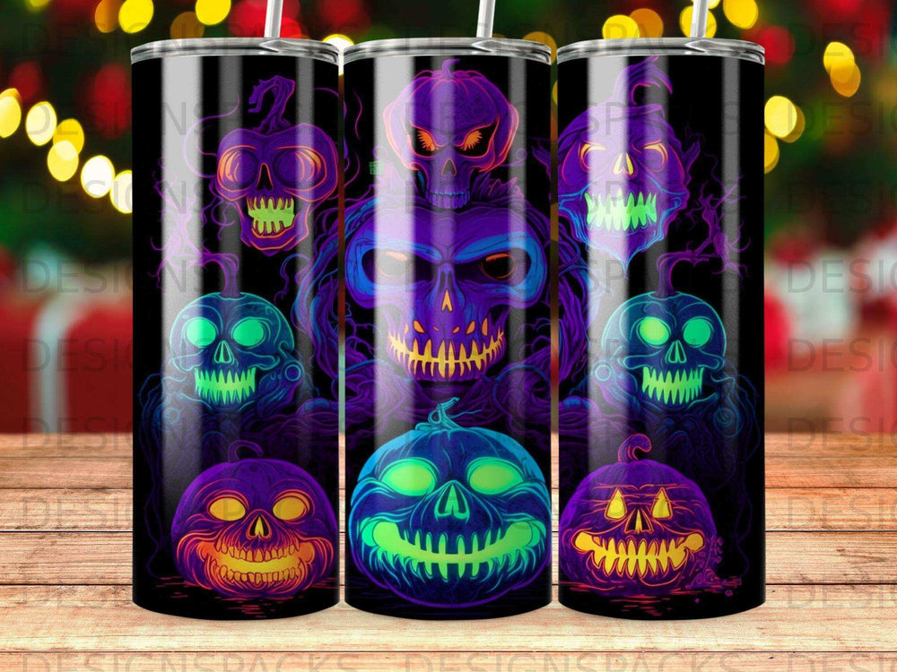 Three tumblers featuring glowing Halloween jack-o'-lanterns and skull designs.