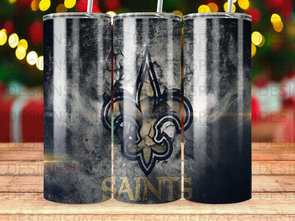 New Orleans Saints fleur-de-lis logo on a distressed black and gold tumbler.