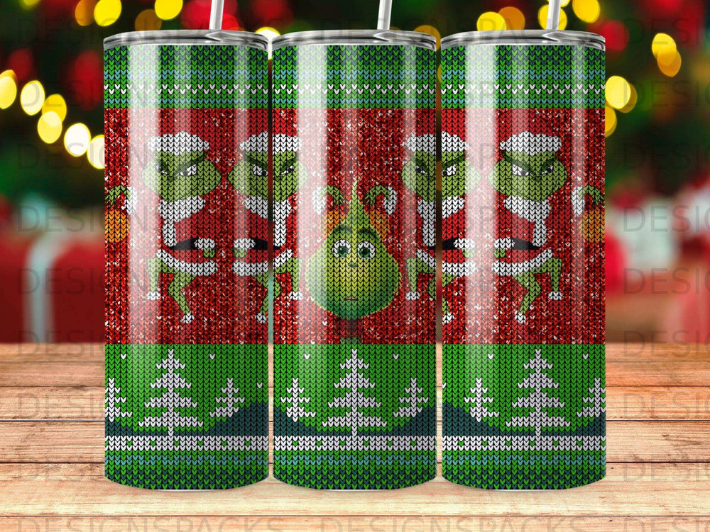 The Grinch in a Santa suit on a tumbler with a green and red knit pattern.