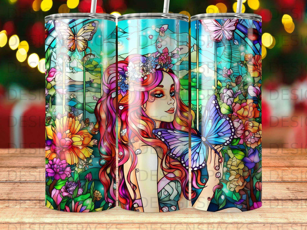 Stained glass tumbler with woman holding a butterfly, surrounded by flowers and stained glass patterns.