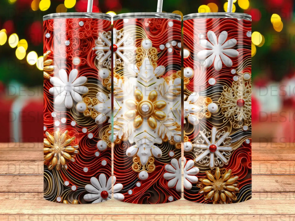 Three tumblers with a red, white, and gold snowflake and swirl design.