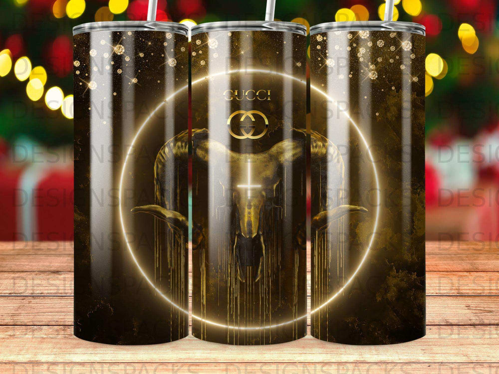 Gold and black tumbler with Gucci logo and ram head design.