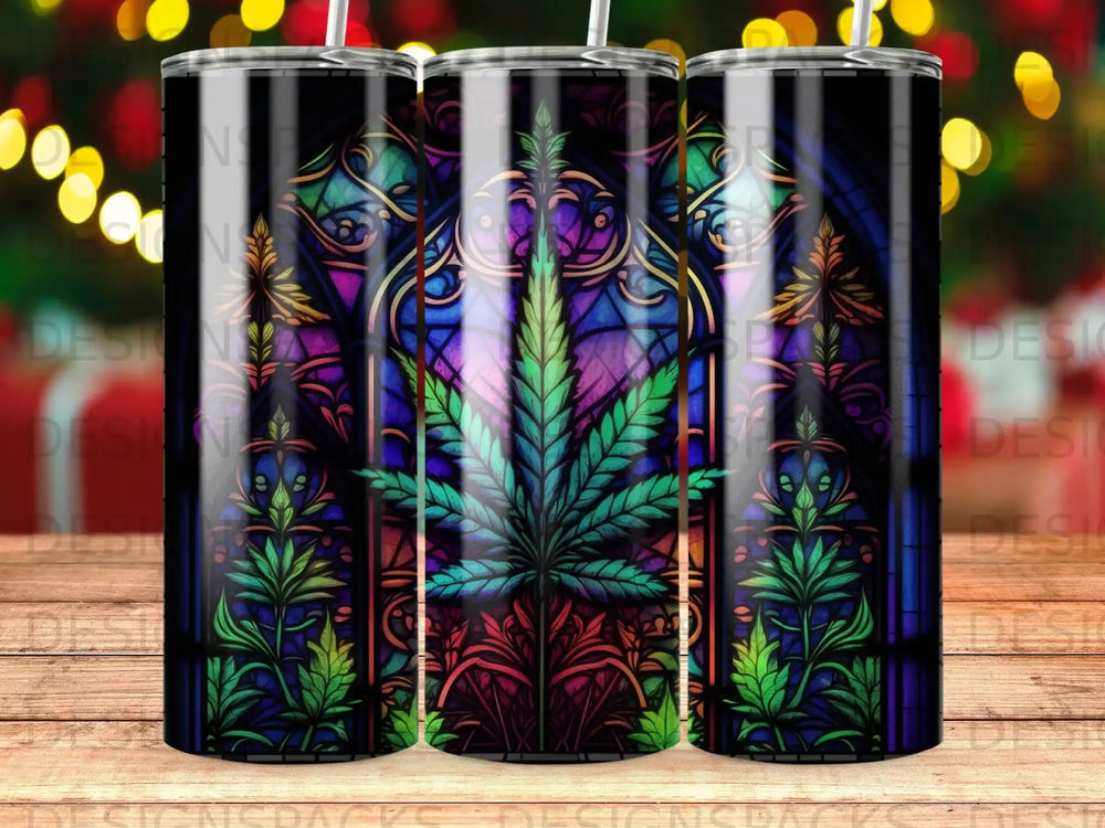 Stained glass tumbler with a cannabis leaf and ornate floral design.