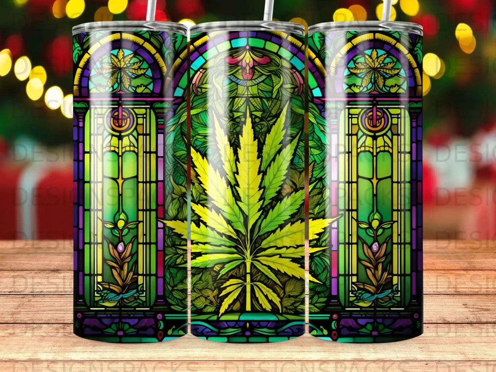 Stained glass tumbler with marijuana leaf design and festive lights background.