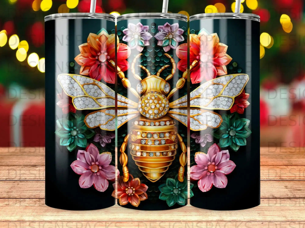 Gold bee with diamond accents surrounded by colorful flowers on a black tumbler.