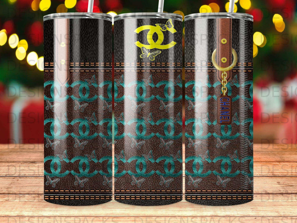 Chanel logo and butterfly pattern on a brown tumbler with strap and gold hardware.