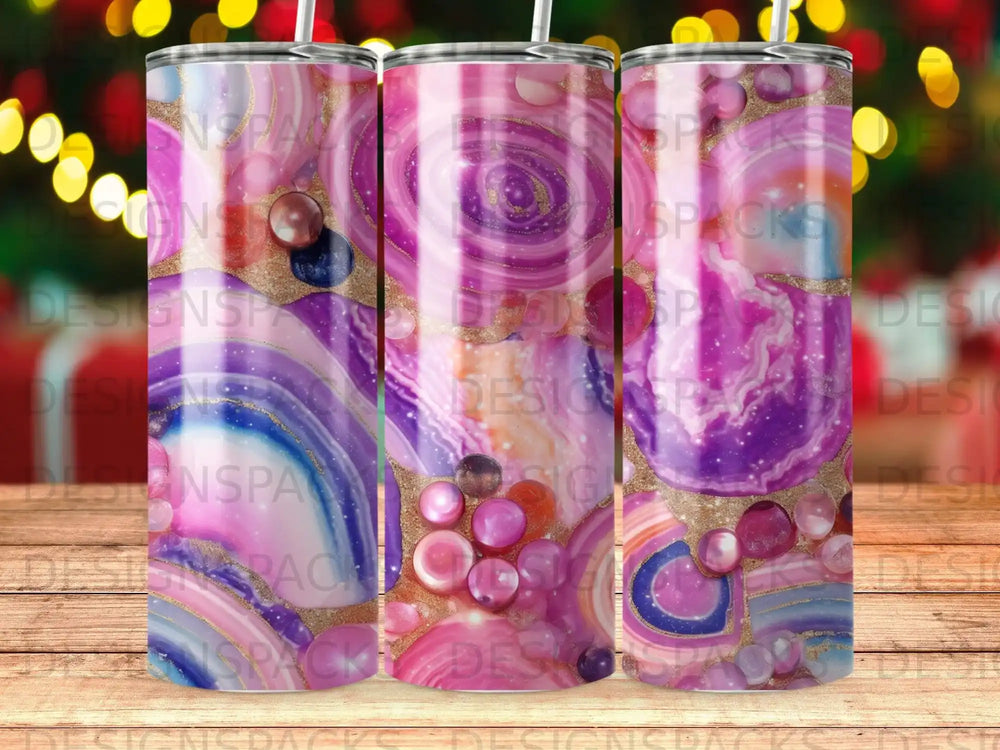 Pink and purple marble tumbler with gold glitter accents and bejeweled accents.