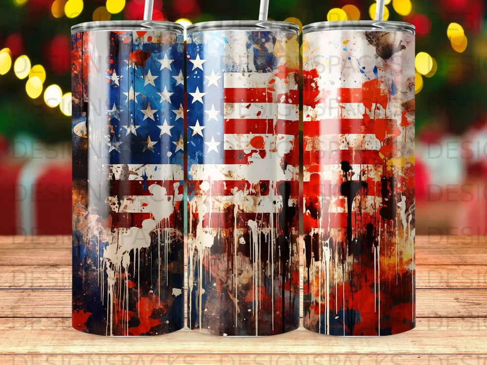 American flag tumbler with distressed paint splatters and patriotic colors.