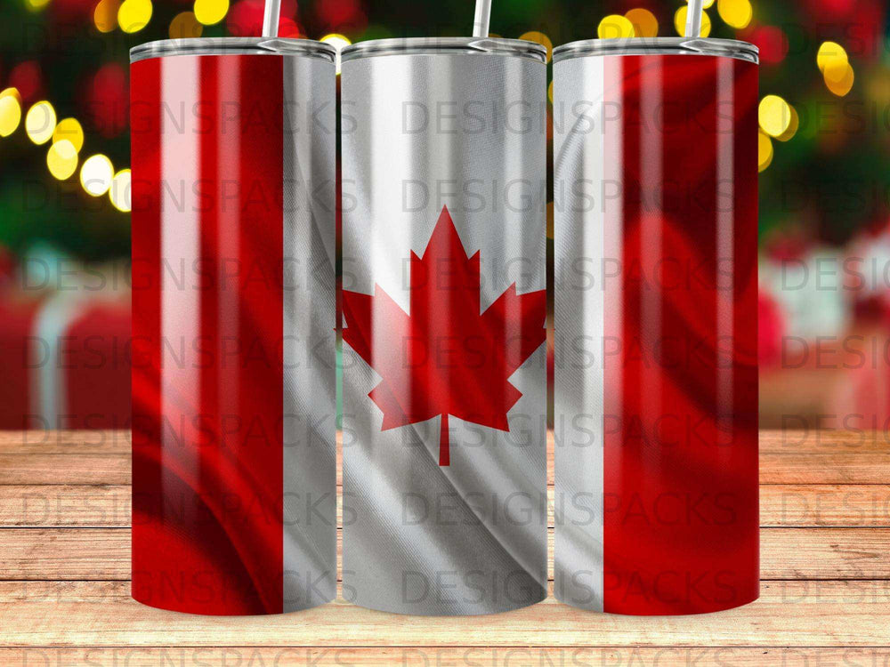 Three tumblers with Canadian flag design and holiday lights background.