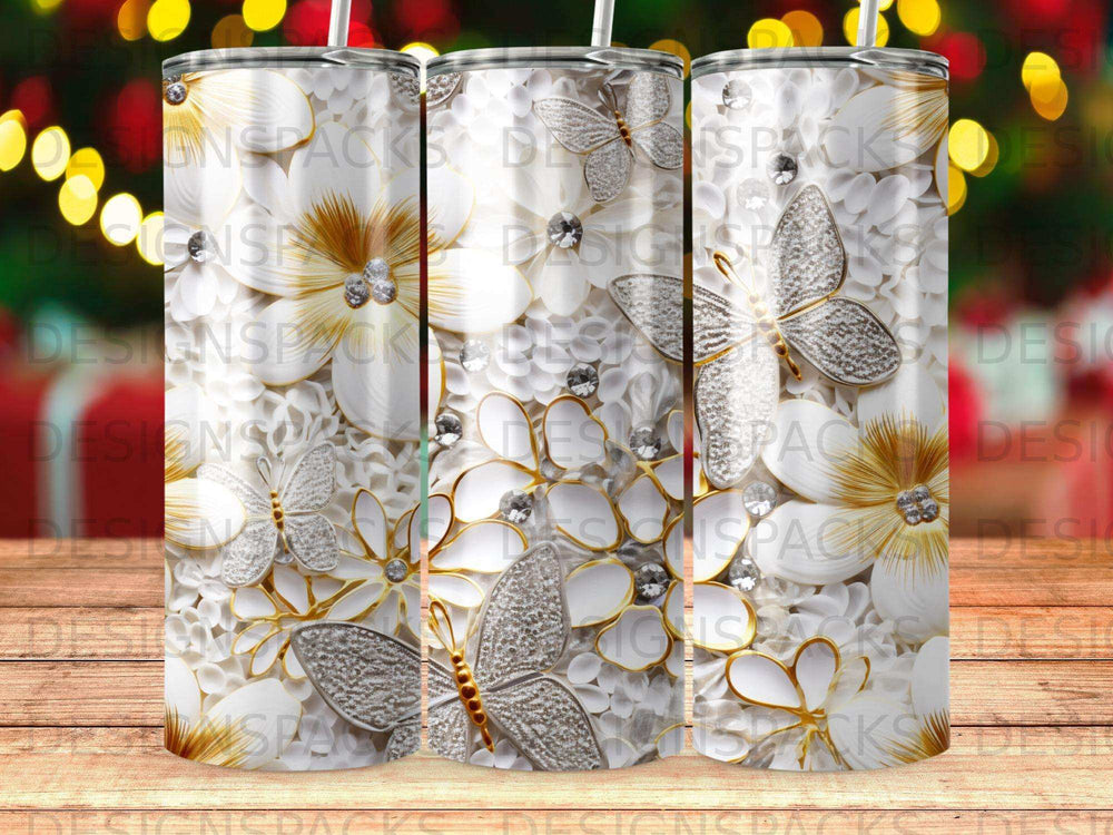 White flowers with silver butterflies and gems on a tumbler.