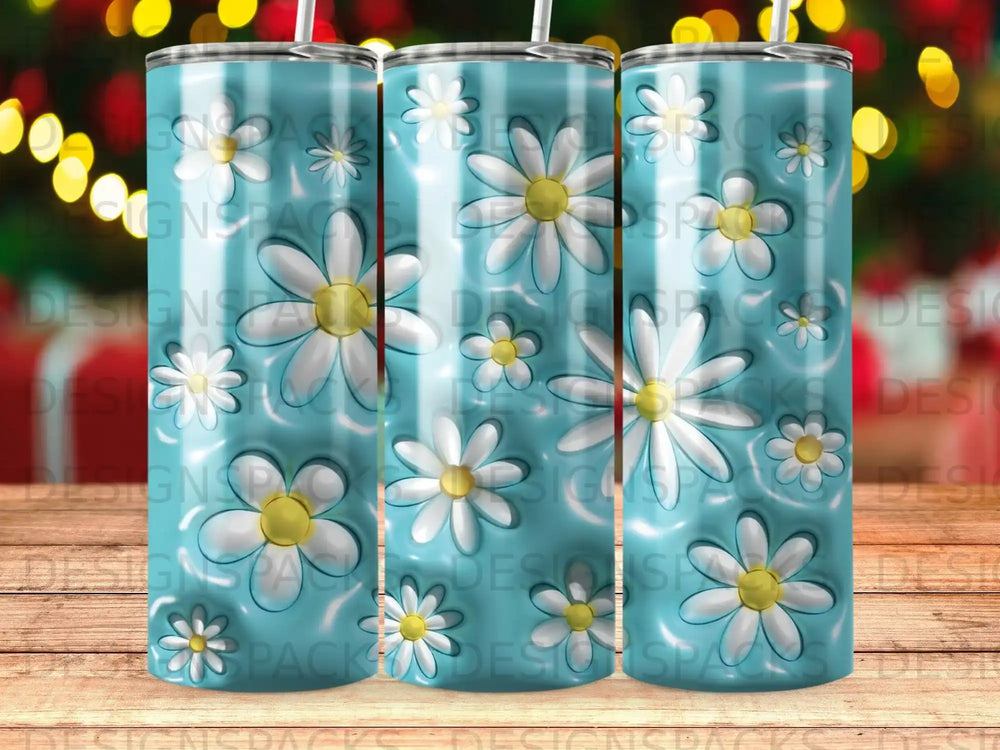 Blue tumbler with a pattern of white daisies.