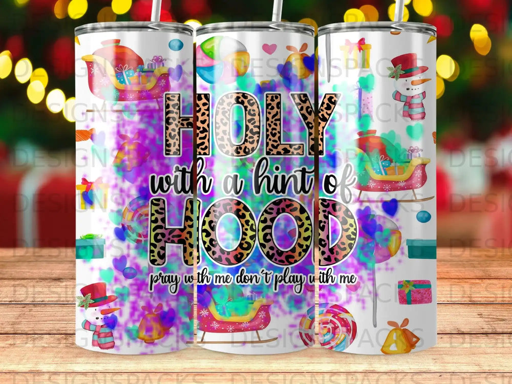 Tumbler with "Holy with a hint of HOOD" and snowman, gift, and candy graphics.